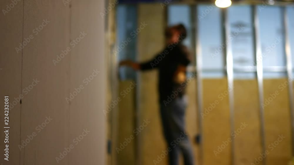 Out of focus contractor looks at his unfinished basement Out of focus contractor looks at his unfinished basement