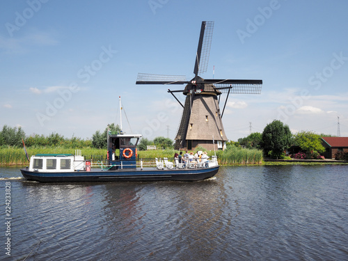 Tour boat with tourists at Kinderdijk windmills