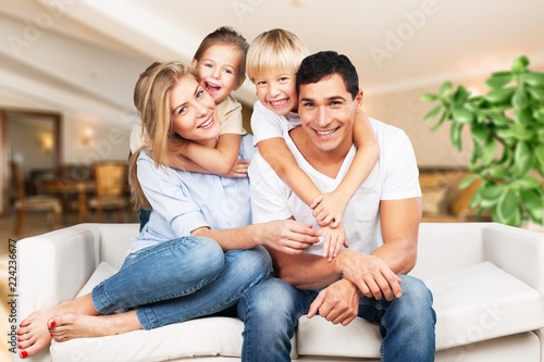 Young family at home smiling at camera