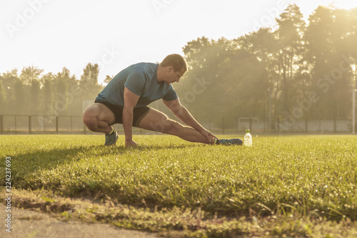  stretching legs.young man doing sports.stretching
