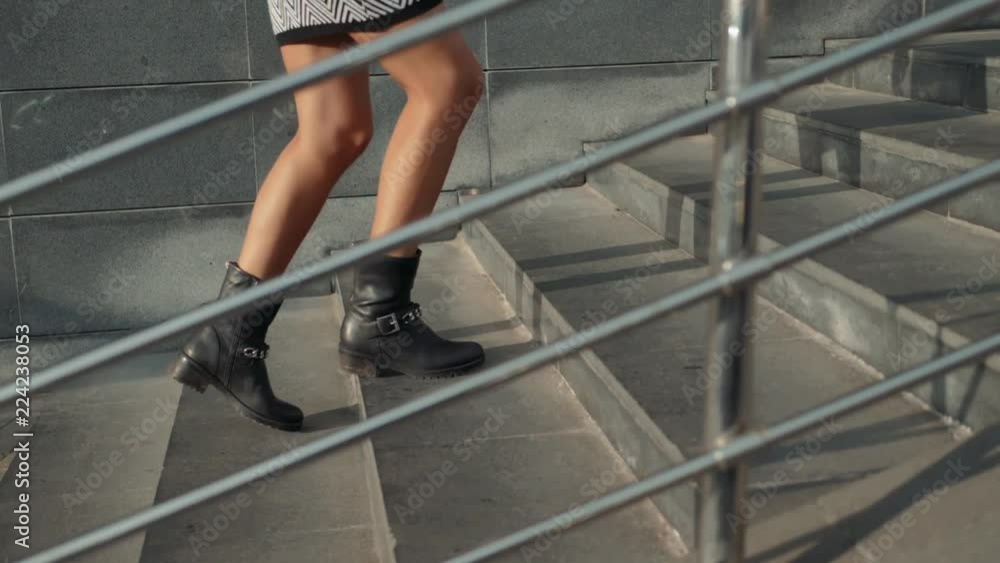 Businesswoman Legs In High-Heeled Shoes Walking Up Stairs On Stairway. Sexy Woman near Office after Work. Student girl go to lessons with phone smartphone slow motion. Businesswoman Legs In High-Heeled Shoes Walking Up Stairs On Stairway. Sexy Woman near Office after Work. Student girl go to lessons with phone smartphone slow motion.