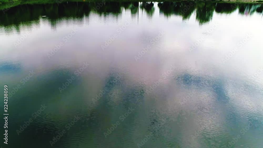 Flying over a lake. close up. trees are reflected in water Flying over a lake. close up. trees are reflected in water