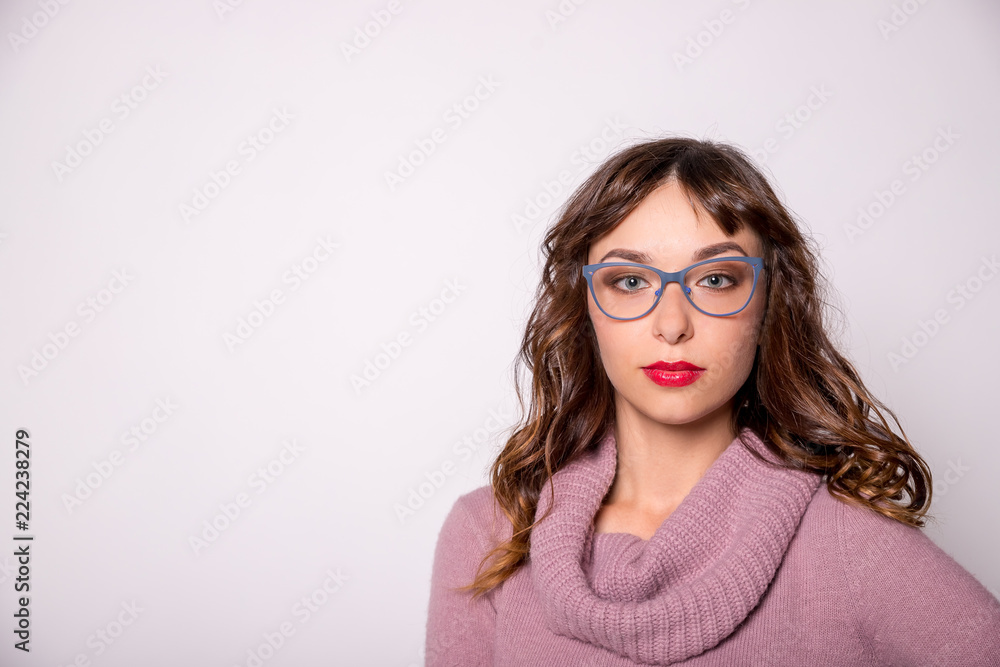 Beauty sexy fashion model girl wearing blue glasses, isolated on white background.young brunette woman with trendy accessories posing in studio.glasses with a blue frame.Health, good vision