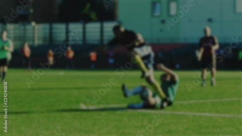 Fullback slides tackle and foul for free kick with not fair paly, soccer game, blurred for background photo