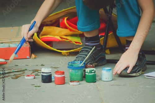 Bottles with gouache paint and brushes.