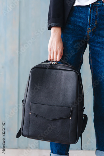 Fashionable woman hold black bag