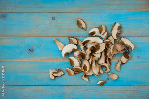 Dried porcini mushrooms on blue wooden background