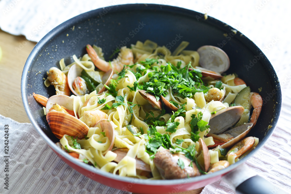 Traditional Italian seafood pasta with fried shrimps and zucchini in a pan
Traditional Italian seafood pasta with fried shrimps and zucchini in a pan