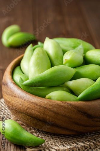 Cyclanthera pedata or kaywa or caigua or achuqcha - Latin American vegetable in bowl on wooden background. Selective focus. photo