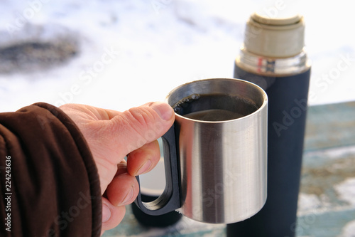 coffee mug in hand in winter