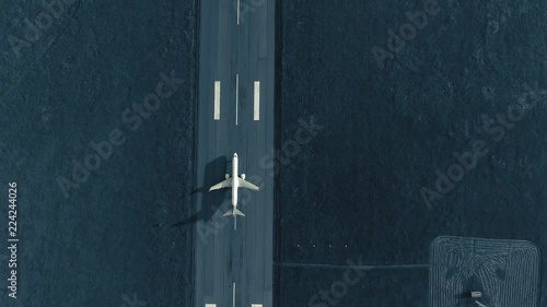 Aerial view of the airplane on take-off approach at the airport runway. top view