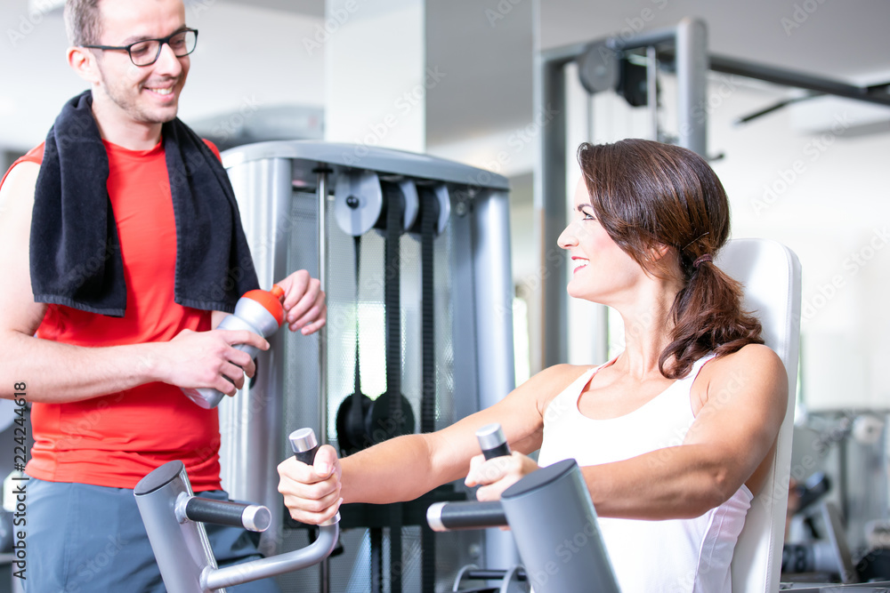beautiful sexy woman man couple are doing a workout in the fitnes gym chest press bench beautiful sexy woman man couple are doing a workout in the fitnes gym chest press bench