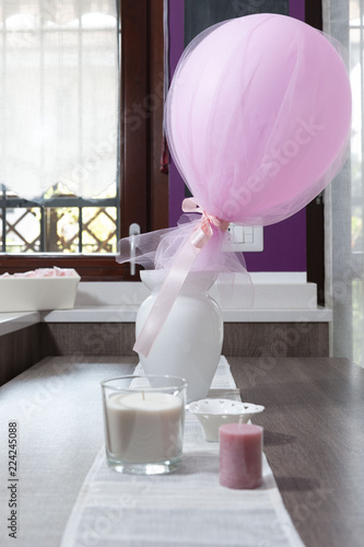 Pink balloon in a white ceramic vase