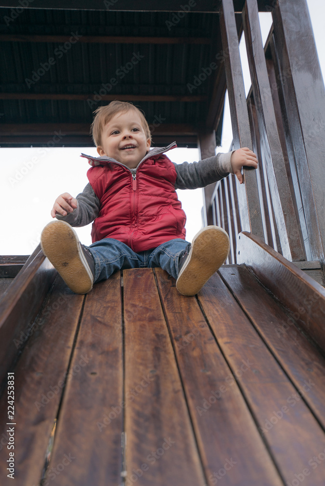 baby boy in a park at the playground baby boy in a park at the playground