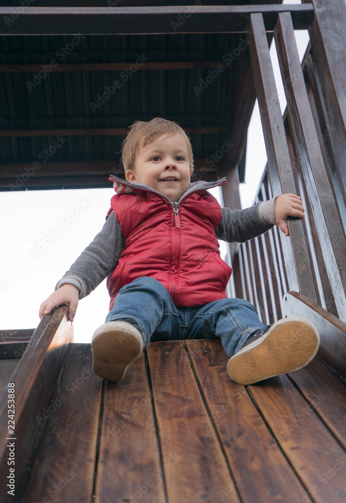 baby boy in a park at the playground baby boy in a park at the playground