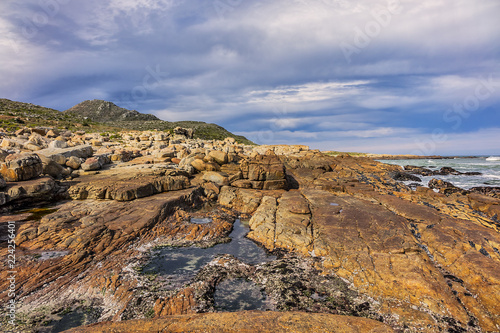 Picturesque view of the rocky shoreline of Atlantic Ocean and Platboom Beach. Platboom Bay is a beautiful beach along coastline nestled in Cape of Good Hope Nature reserve, Cape Town, South Africa.