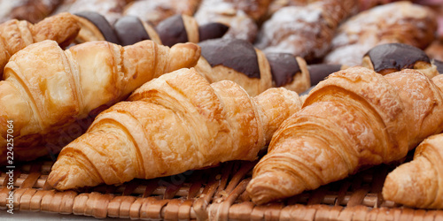 beautiful appetizing croissants on a wicker napkin in a cafe or on a storefront in a store