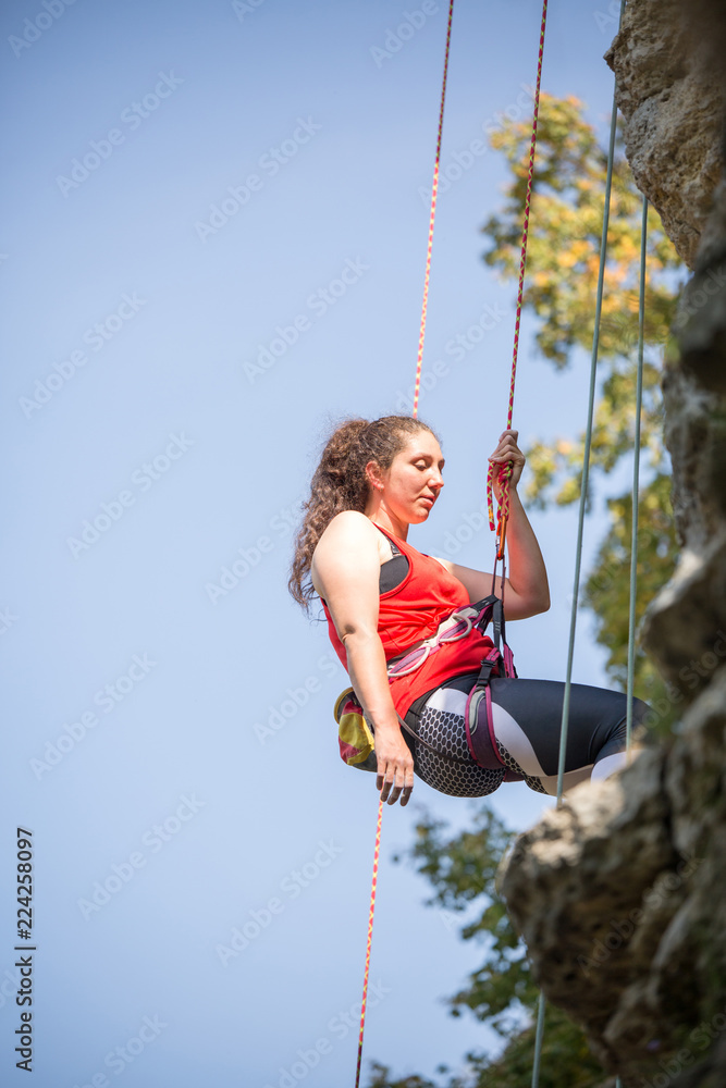 Photo of athlete woman clambering over rock