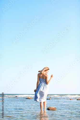 Young woman enjoying sunny day on beach