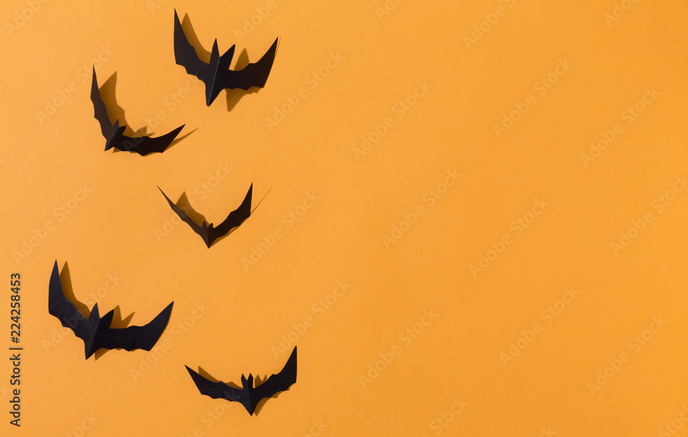 Fototapeta premium Halloween paper bats overhead view on a solid color