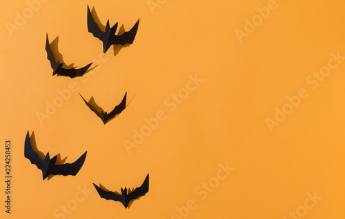 Halloween paper bats overhead view on a solid color