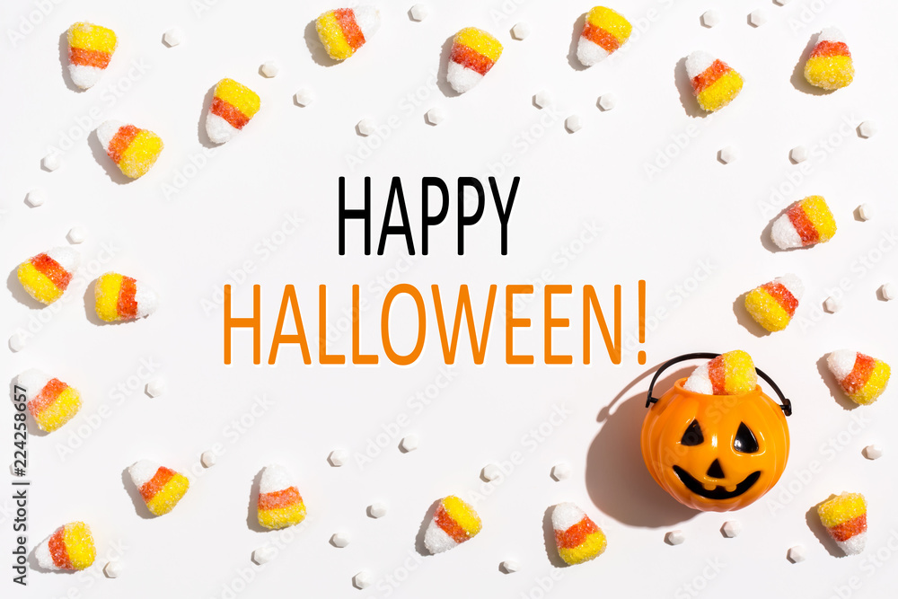 Happy Halloween message with pumpkin overhead view on a solid color Happy Halloween message with pumpkin overhead view on a solid color
