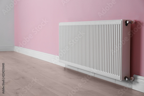 Wallpaper Mural Modern radiator on color wall indoors. Central heating system Torontodigital.ca