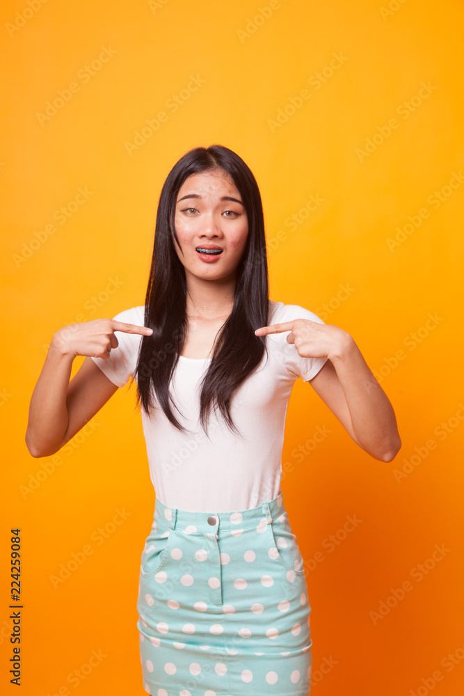 Young Asian woman point at herself ask why me. Young Asian woman point at herself ask why me.