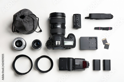 Flat lay composition with photographer's equipment and accessories on white background