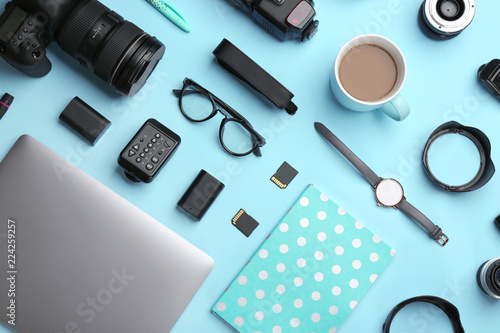 Flat lay composition with photographer's equipment and accessories on color background