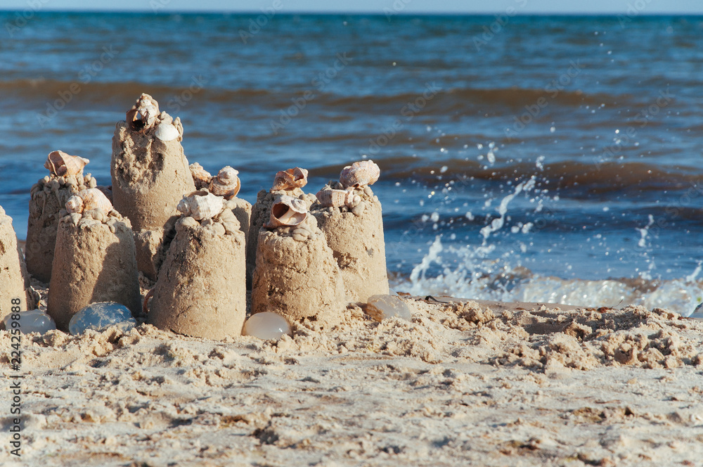 built castle of sand on the beach of the ocean on a clear summer day a clear sunny summer