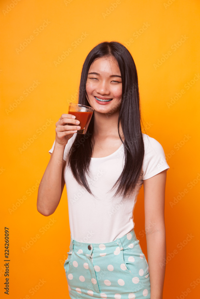 Young Asian woman drink tomato juice. Young Asian woman drink tomato juice.