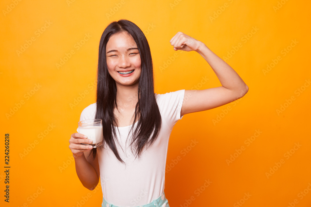 Healthy Asian woman drinking a glass of milk. Healthy Asian woman drinking a glass of milk.