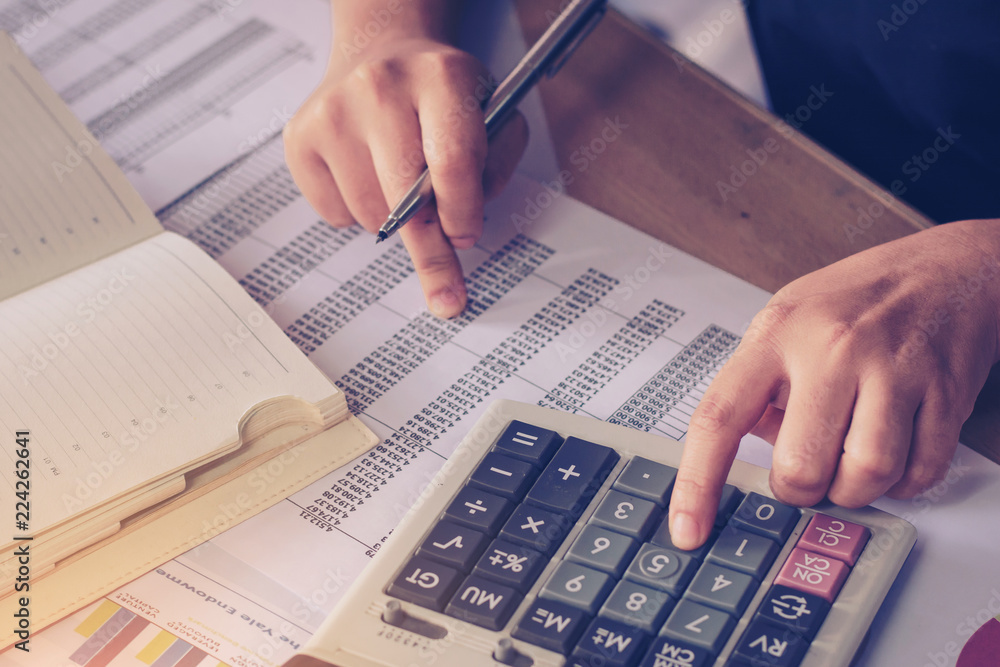 Business concep : close up woman hand using calculator and writing make note with calculate at office desk. Business concep : close up woman hand using calculator and writing make note with calculate at office desk.