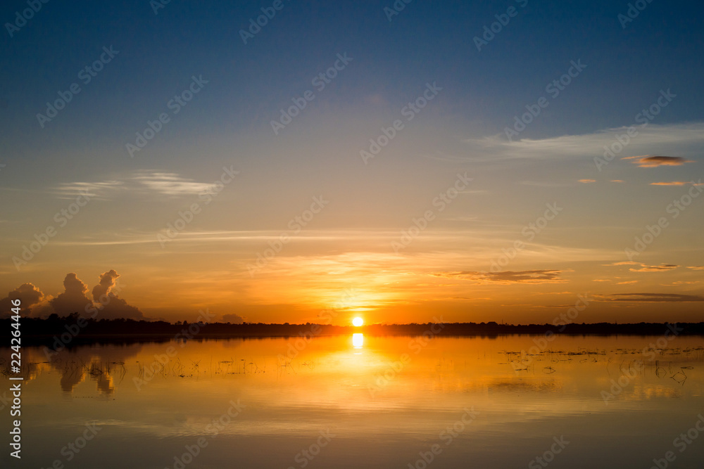 Sunset in the lake. beautiful sunset behind the clouds above the over lake landscape background. dramatic sky with cloud at sunset Sunset in the lake. beautiful sunset behind the clouds above the over lake landscape background. dramatic sky with cloud at sunset