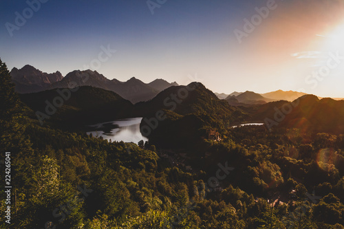 European mountain sunset overlooking forest, valley and lake.