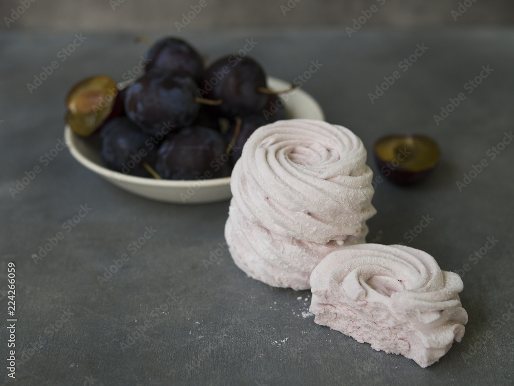 Homemade plum marshmallows on gray background. Russian pink zephyr. Selective focus. Close up, copy space Homemade plum marshmallows on gray background. Russian pink zephyr. Selective focus. Close up, copy space
