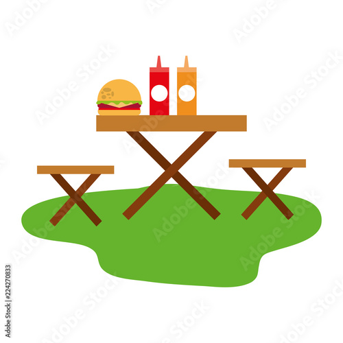 picnic chairs with hamburger and bottle of sauces