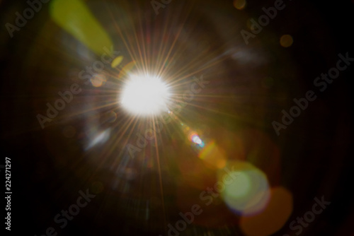 solar lens flare over black background
