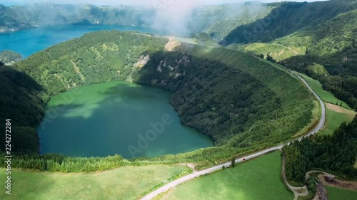Flying over Lagoa Verde and Lagoa Azul, lakes in Sete Cidades volcanic craters on San Miguel island, Azores, Portugal. 