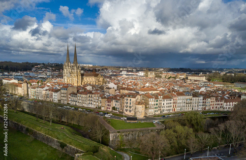 Aerial panorama view of Bayonne France with the medieval cathedral, colorful traditional French houses stormy cloudy sky in the background © tamas