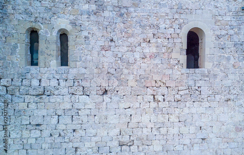 Stone wall with Romanesque windows on the Templar crusader castle of Miravet in Tarragona  Spain.