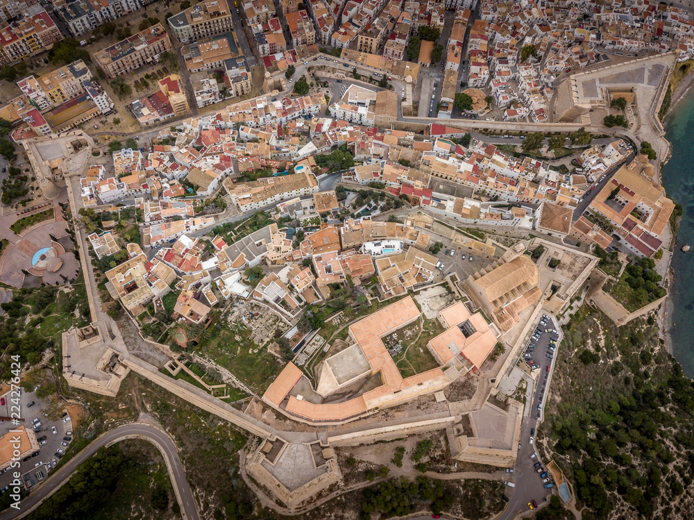 Obraz premium Aerial panorama of Ibiza town with fortifications, bastions, walls, churches, white houses against blue stormy cloudy sky