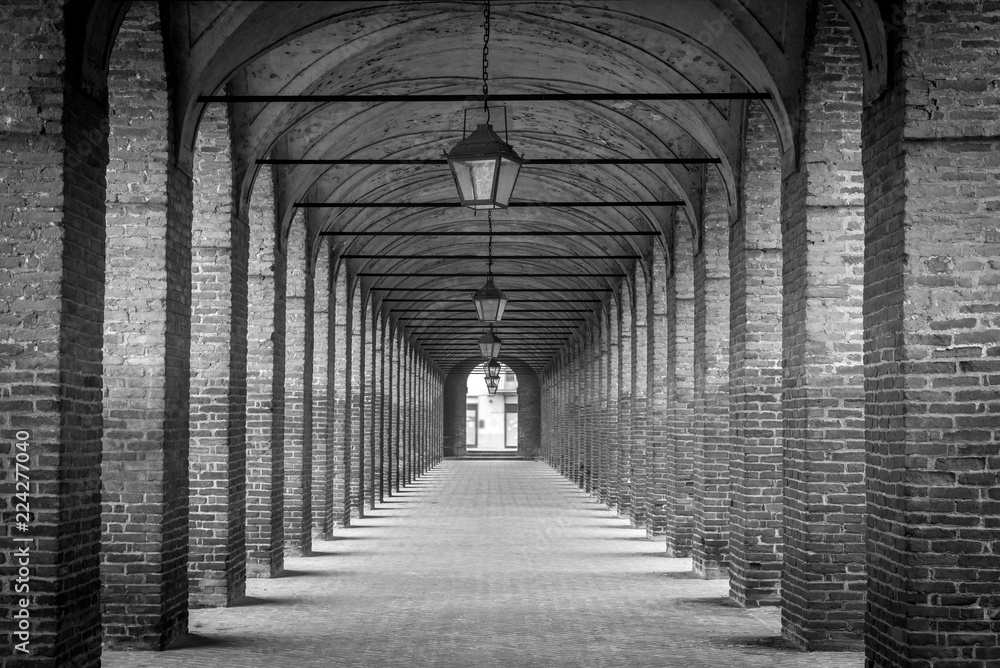 Black and white view of the Sabbioneta open gallery with brick arches Black and white view of the Sabbioneta open gallery with brick arches
