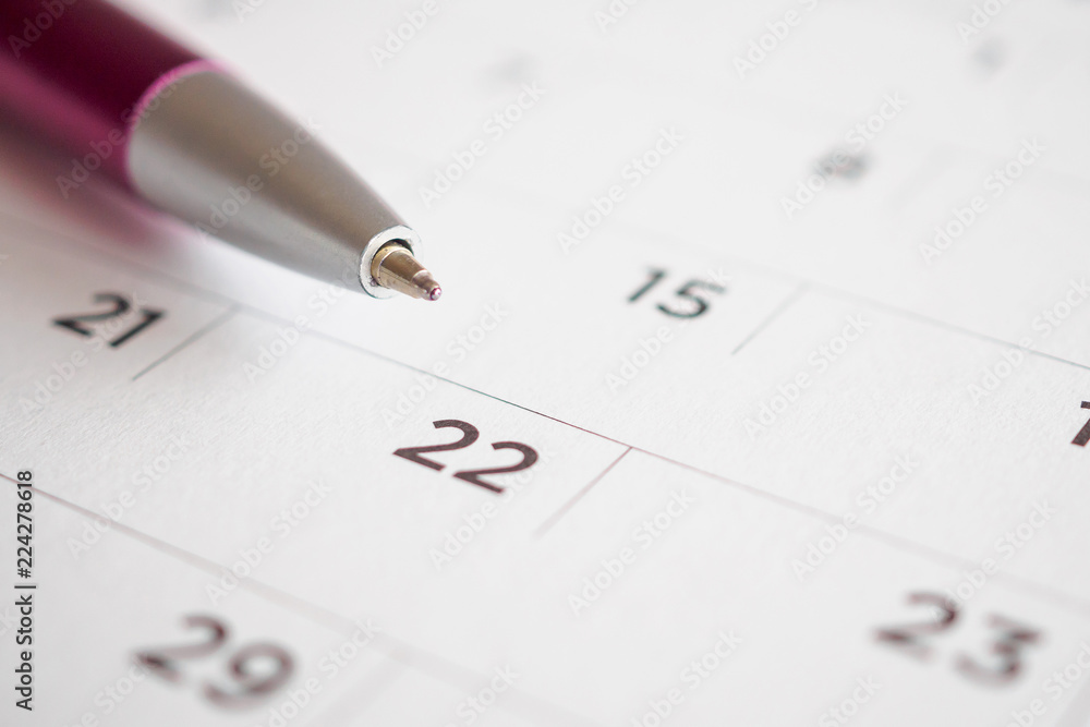 Calendar page with pen point at 22nd date Calendar page with pen point at 22nd date