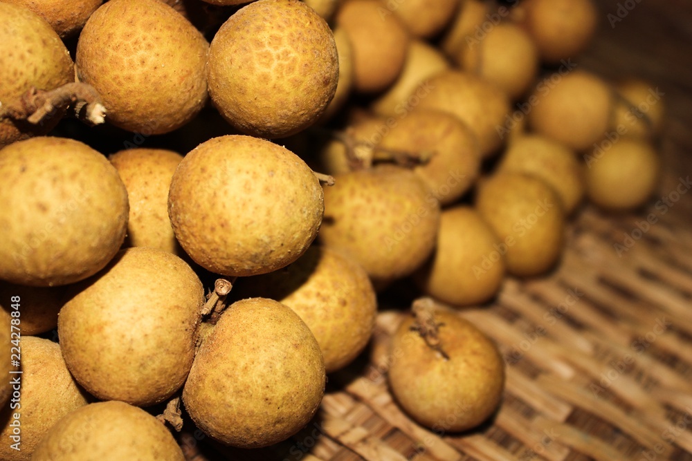 Longan fruits or Dimocarpus longan or Dragon eye fruit on the wooden wicker. Longan fruits or Dimocarpus longan or Dragon eye fruit on the wooden wicker.