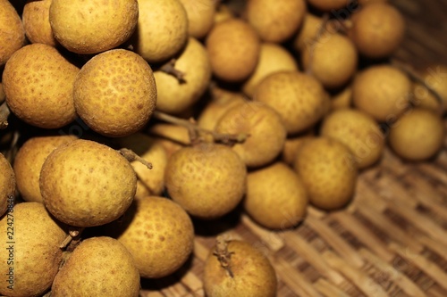 Longan fruits or Dimocarpus longan or Dragon eye fruit on the wooden wicker.