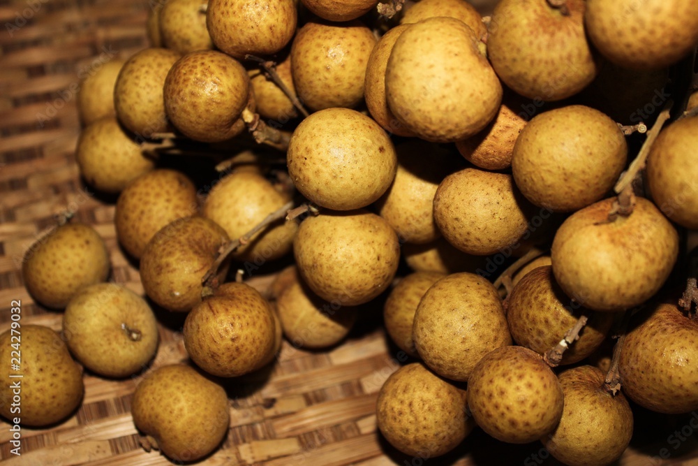 Longan fruits or Dimocarpus longan or Dragon eye fruit on the wooden wicker. Longan fruits or Dimocarpus longan or Dragon eye fruit on the wooden wicker.