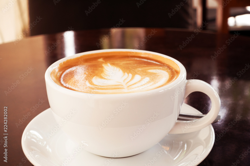 Hot coffee latte on a wooden table.