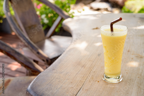 Refreshing And Healthy Mango Smoothie On Wooden Table